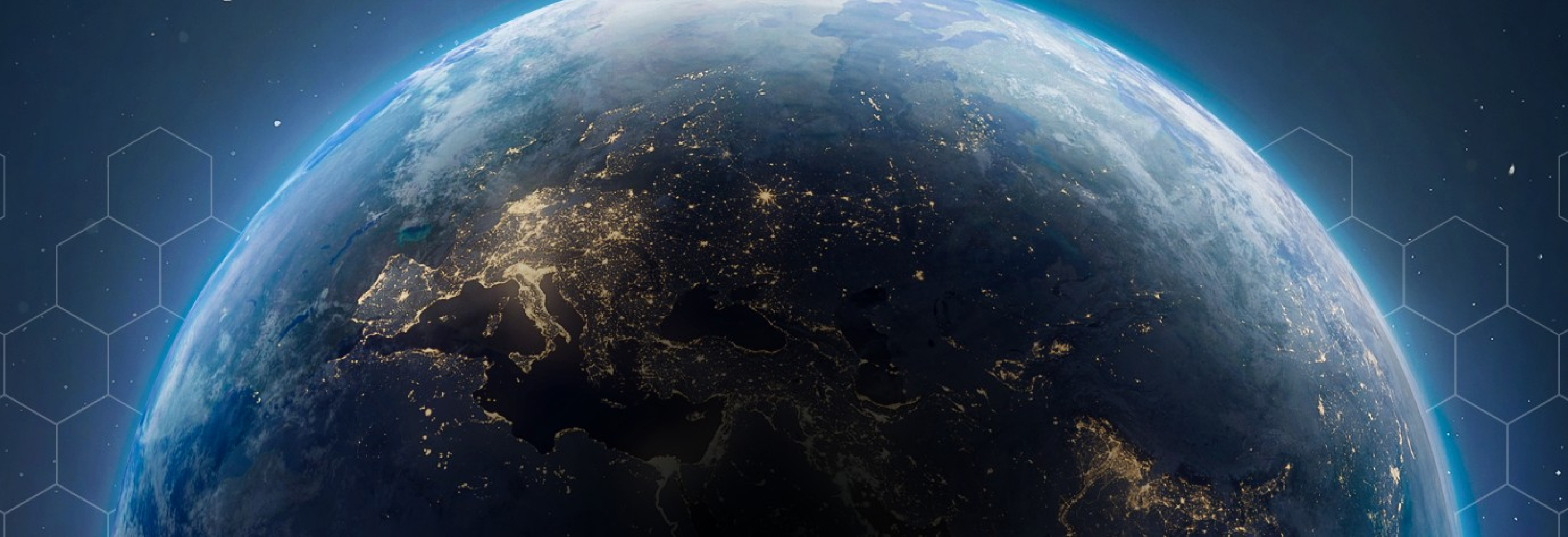 View of Earth from space at night, with city lights visible across Europe, the Middle East, and parts of Asia.