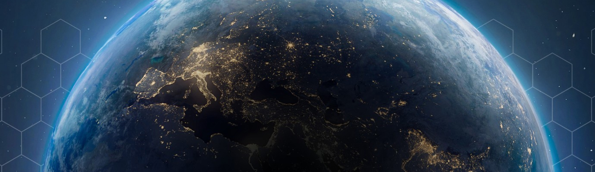 View of Earth from space at night, with city lights visible across Europe, the Middle East, and parts of Asia.